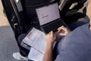 Craftsman working on laptop in van